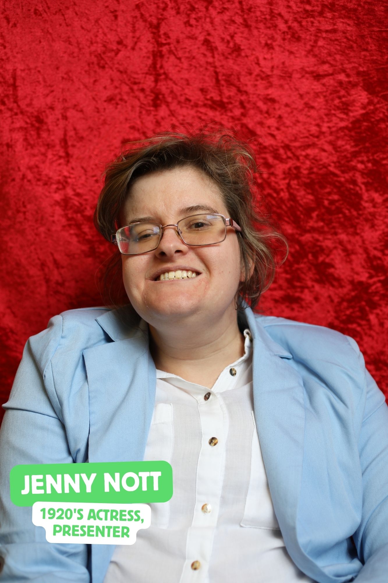 Jenny, a white woman who uses a wheelchair, plays the presenter. She is wearing a blue blazer.